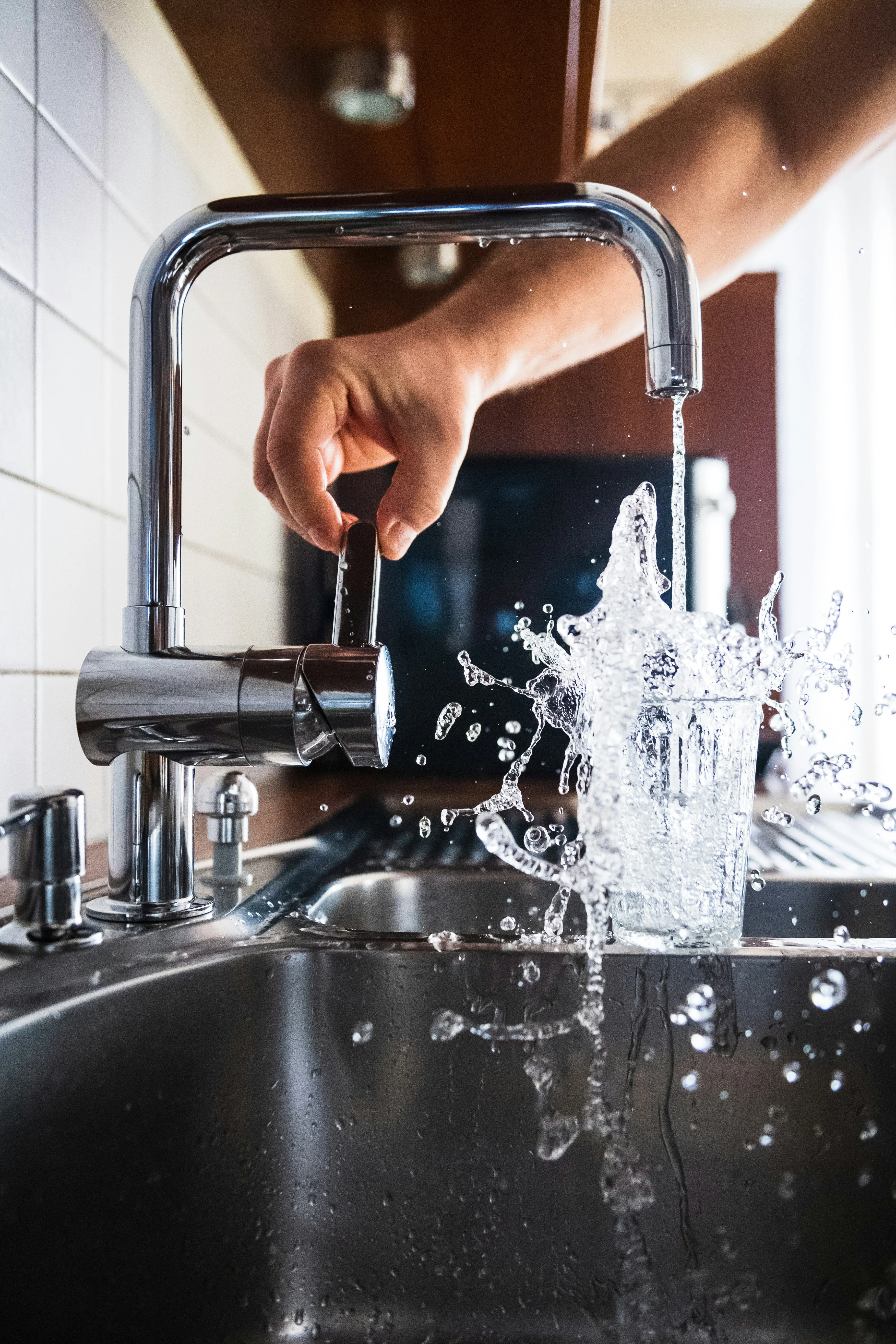 Modern chrome kitchen faucet with a strong water stream and splash