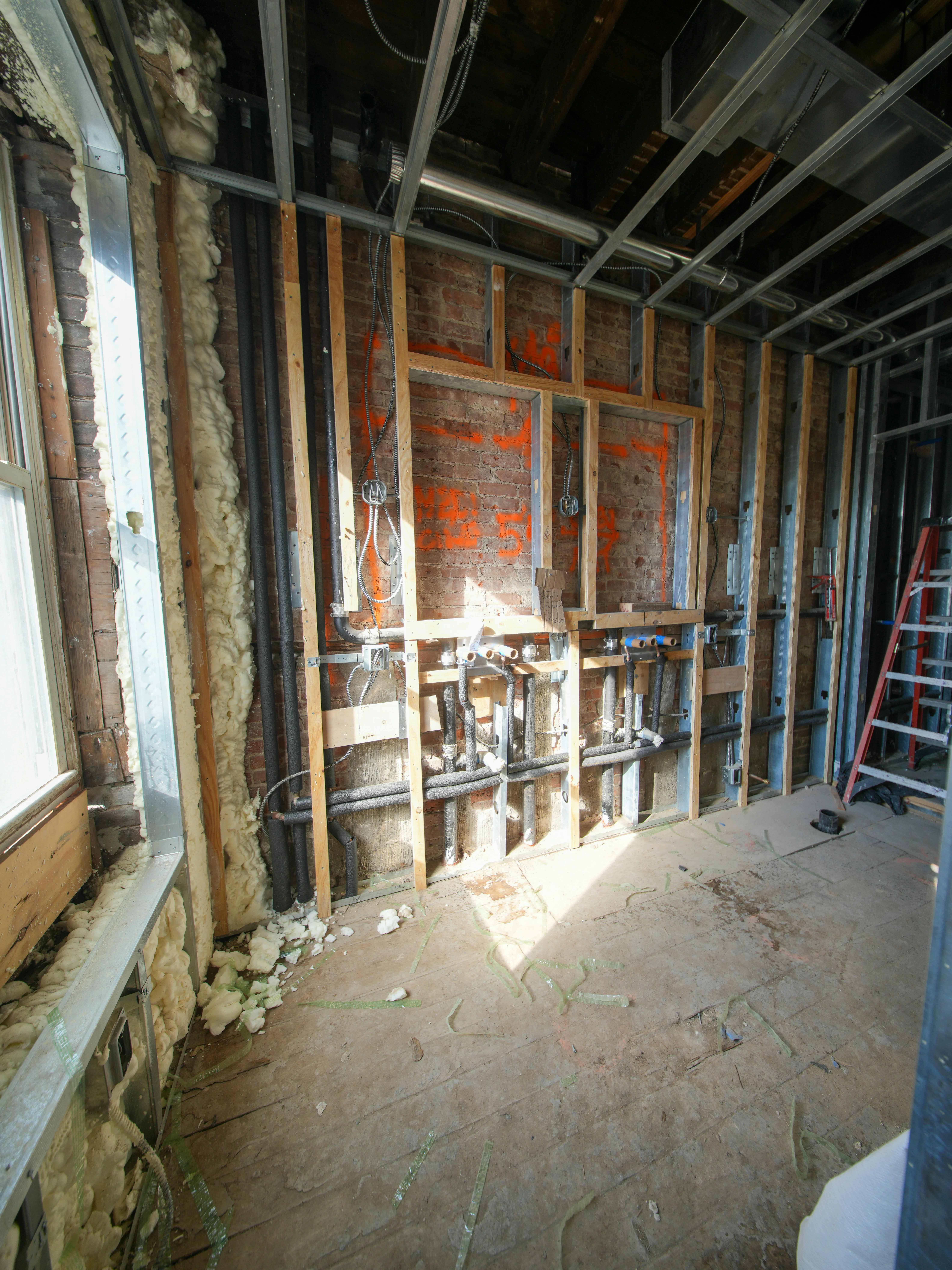 Rough-in plumbing installation in open walls during renovation